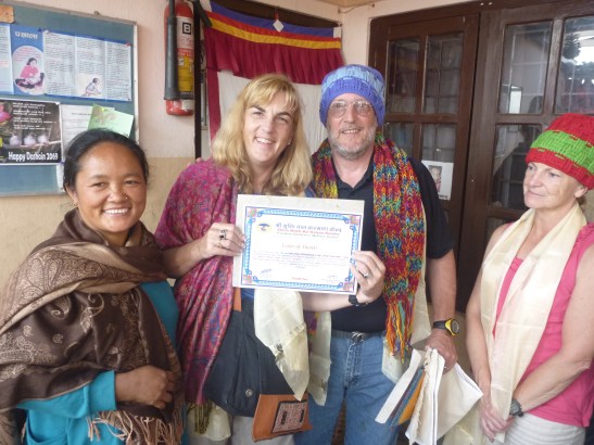 Joan and John receiving a certificate of apprecuation